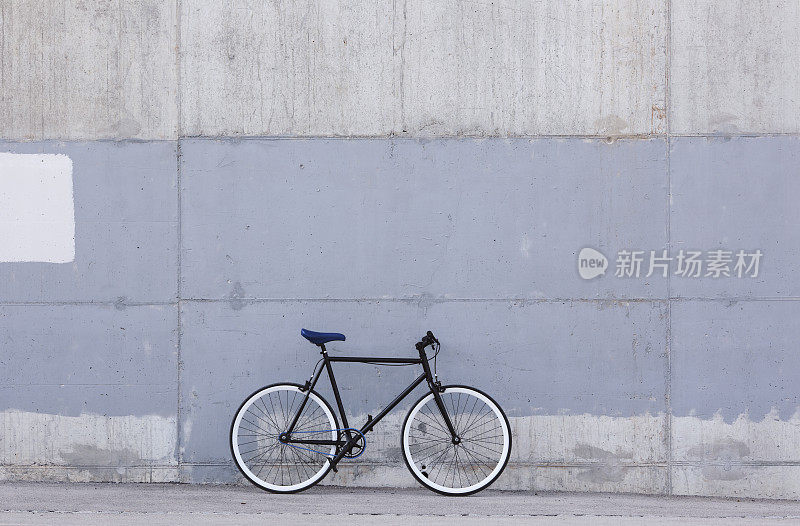 City bicycle against concrete background